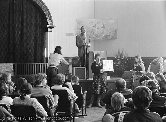 Bob Avery was the auctioneer as Sally Welty displays a work of art during the 1st Annual Mendocino Whale Festival at Crown Hall, March 1976.