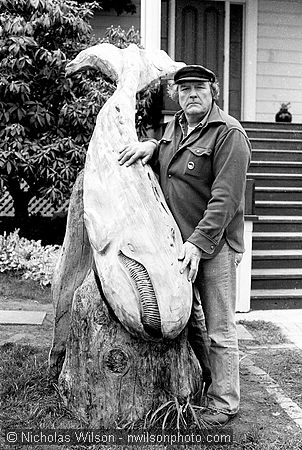 Byrd Baker poses with his driftwood whale sculpture in front of Mendocino's MacCallum House Inn. Baker championed the cause of stopping commercial whaling when he helped organize the Mendocino Whale War in 1976.