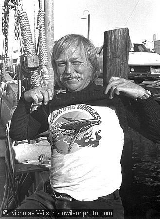 J. D. Mayhew models the Save The Whales T-shirt he designed for the Mendocino Whale War. He was aboard the Whale War's boat in San Francisco preparing to embark on the 1976 anti-whaling voyage. Photo © 1976 Nicholas Wilson, PO Box 943, Mendocino CA 95460. Neg. 6-26-76-19. Scanned from vintage 8x10 print at 300 dpi on 2/19/01.