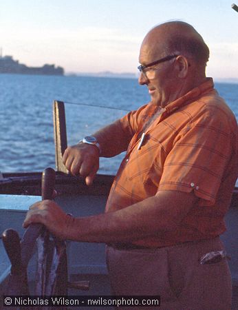 Capt. John Cormack checks his watch at the helm of the Phyllis Cormack as the 1976 voyage of the Mendocino Whale War was about to begin.