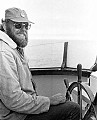 John Griffith at the helm of the Mendocino Whale War boat Phyllis Cormack on patrol for Russian whalers off Cape Mendocino during the summer of 1976.<br /><br /><br />Neg 7-1-76-20, scanned from neg @ 2700 dpi with Nikon LS-2000 on 2/19/01.