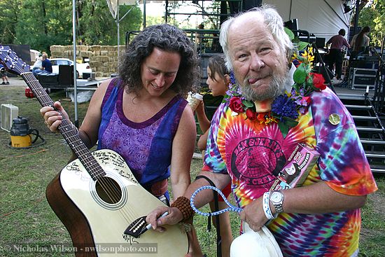 Wavy Gravy adds his signature to a guitar raffled for a charity benefit during the Kate Wolf Music Festival 2005.