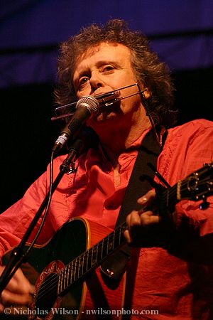 Donovan with guitar and harmonica