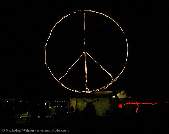 The 12' diameter lighted peace symbol glows in the backstage dining area after the music ends