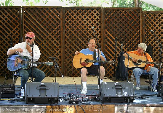 Garnet Rogers, Steve Seskin and Cris Williamson between songs at the Arlo Hagler Memorial stage Sunday afternoon