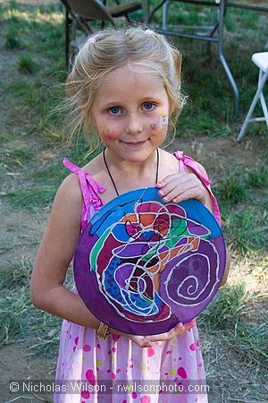 Joe Craven's daughter Hattie shows her painted silk creation backstage. Hattie played fiddle with the Laura Love Band Saturday night.