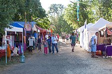 Vendor booths line the pathway to the main concert bowl.