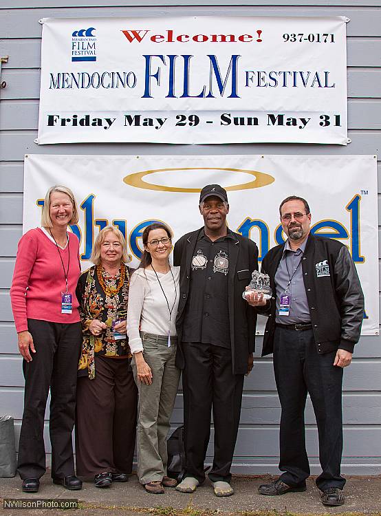 Actor Danny Glover outside Crown Hall with Mendocino Film Festival organizers  Ann Walker, Pat Ferrero, Betsy Ford and Keith Brandman, who holds Glover's special Wave of Change Award trophy, presented in 2009.