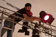Nick Tringale adjusts a stage light.