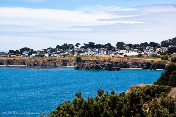 Town of Mendocino with the Mendocino Music Festival's big white 850-seat tent concert hall overlooking Mendocino Bay and the blue Pacific Ocean.
