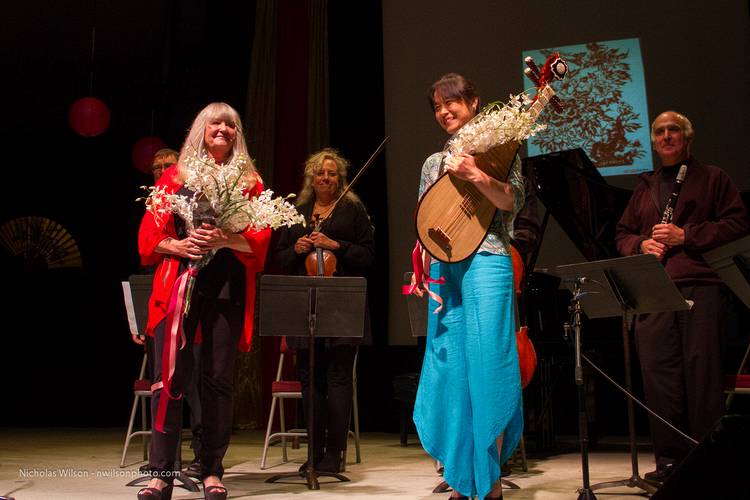Susan Waterfall and Wu Man hold orchid bouquets at the end of Music for a Teahouse.