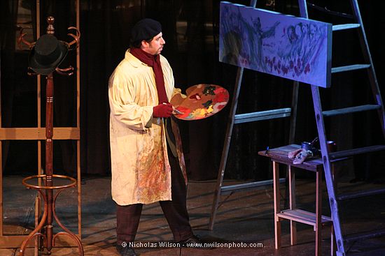 Act I of La Boheme begins in a Paris artists' garret where Marcello (Baritone Adam Juran) is painting a picture.
